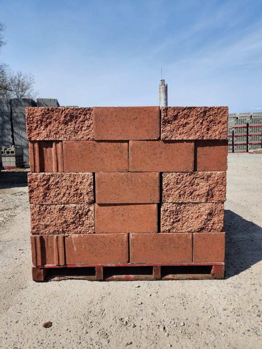A pile of red bricks sitting on top of a wooden pallet.