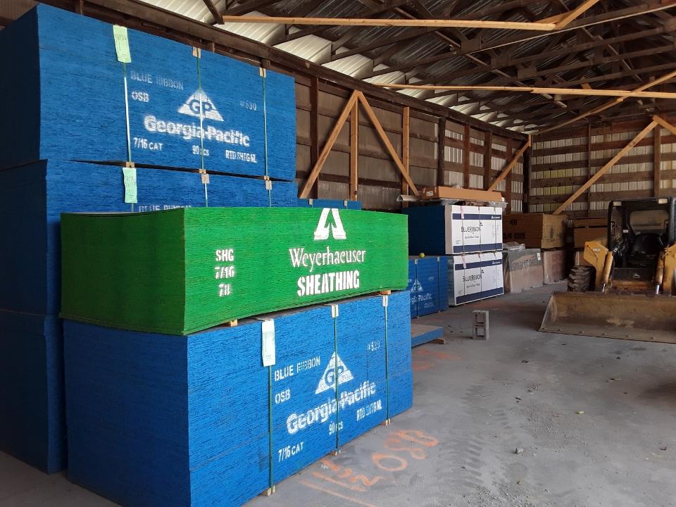 A warehouse with blue and green boxes stacked on top of each other