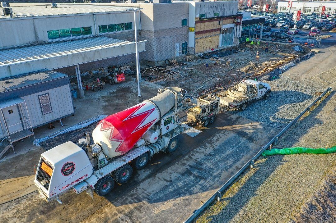 An aerial view of a concrete mixer truck at a construction site.