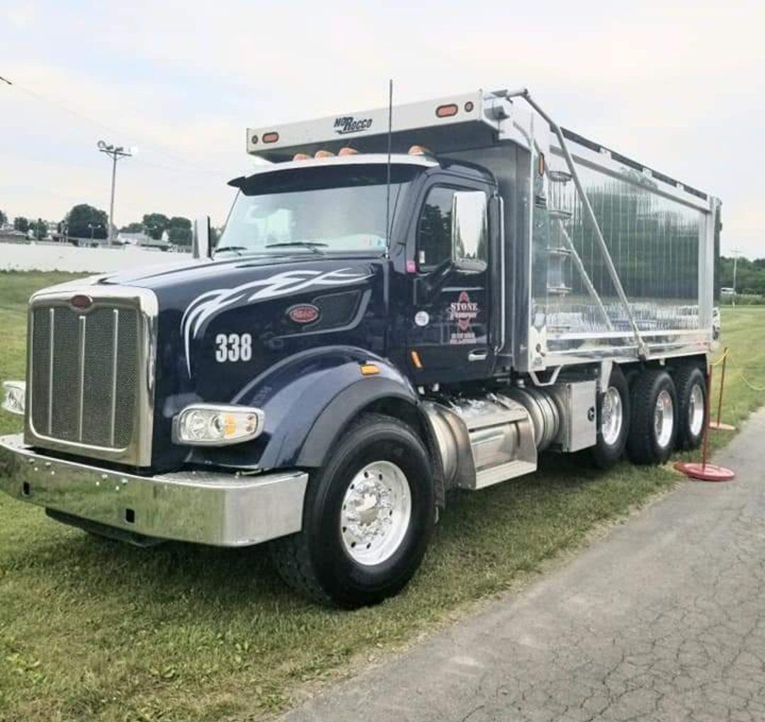 A dump truck is parked on the side of the road.