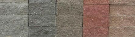 A row of bricks of different colors are lined up in a row.