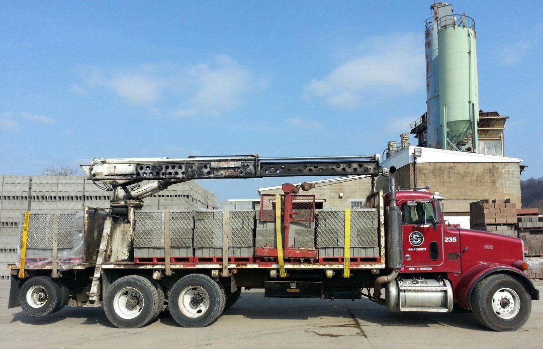 A red truck with a crane on the back of it
