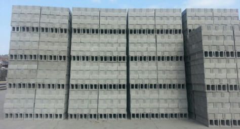 A large stack of concrete blocks against a blue sky