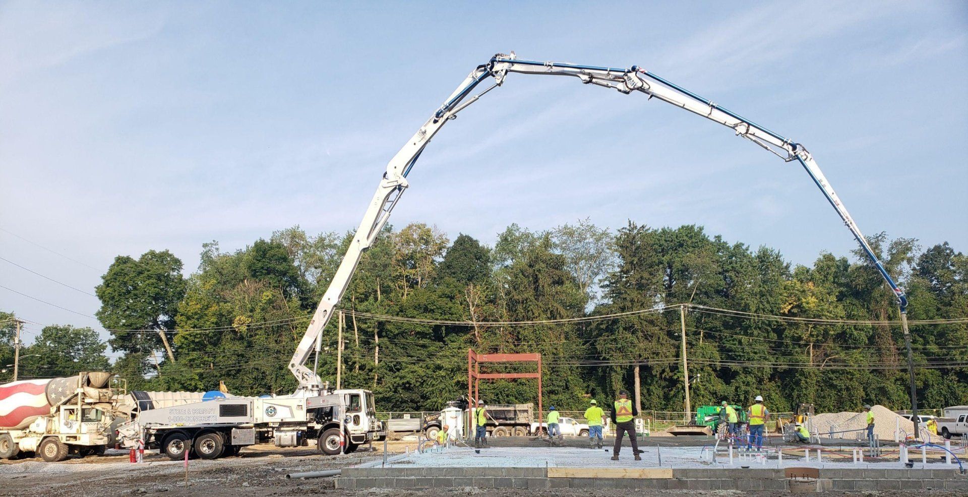A concrete pump is being used to pour concrete on a construction site.