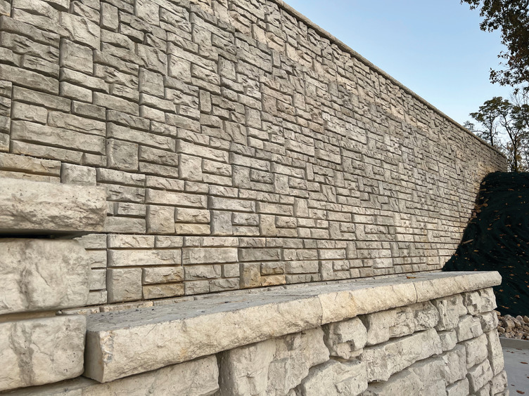 A large stone wall with a ledge on the side of it.