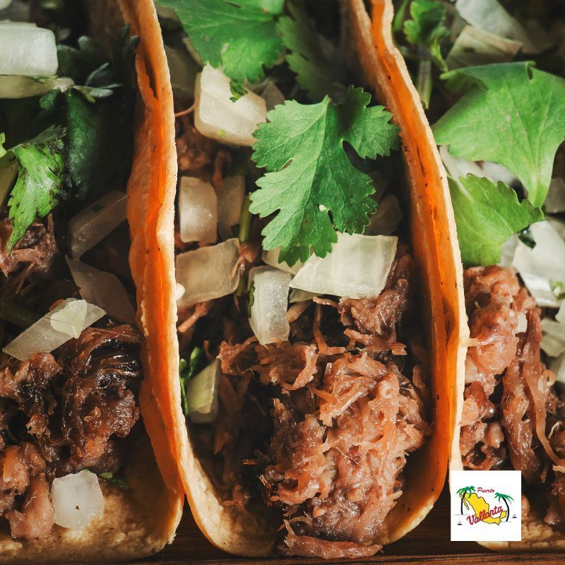 A close up of three tacos with meat and vegetables