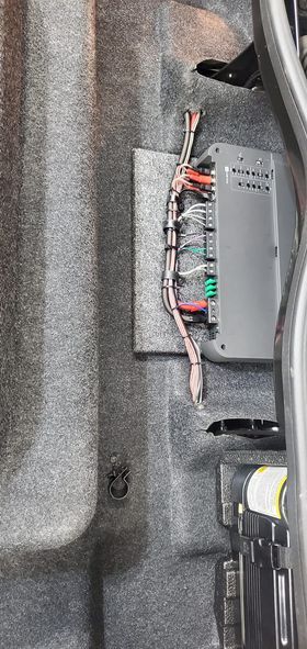 A close up of a fuse box in the back of a car