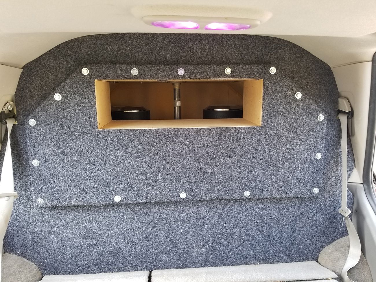 The back of a car with two speakers in it