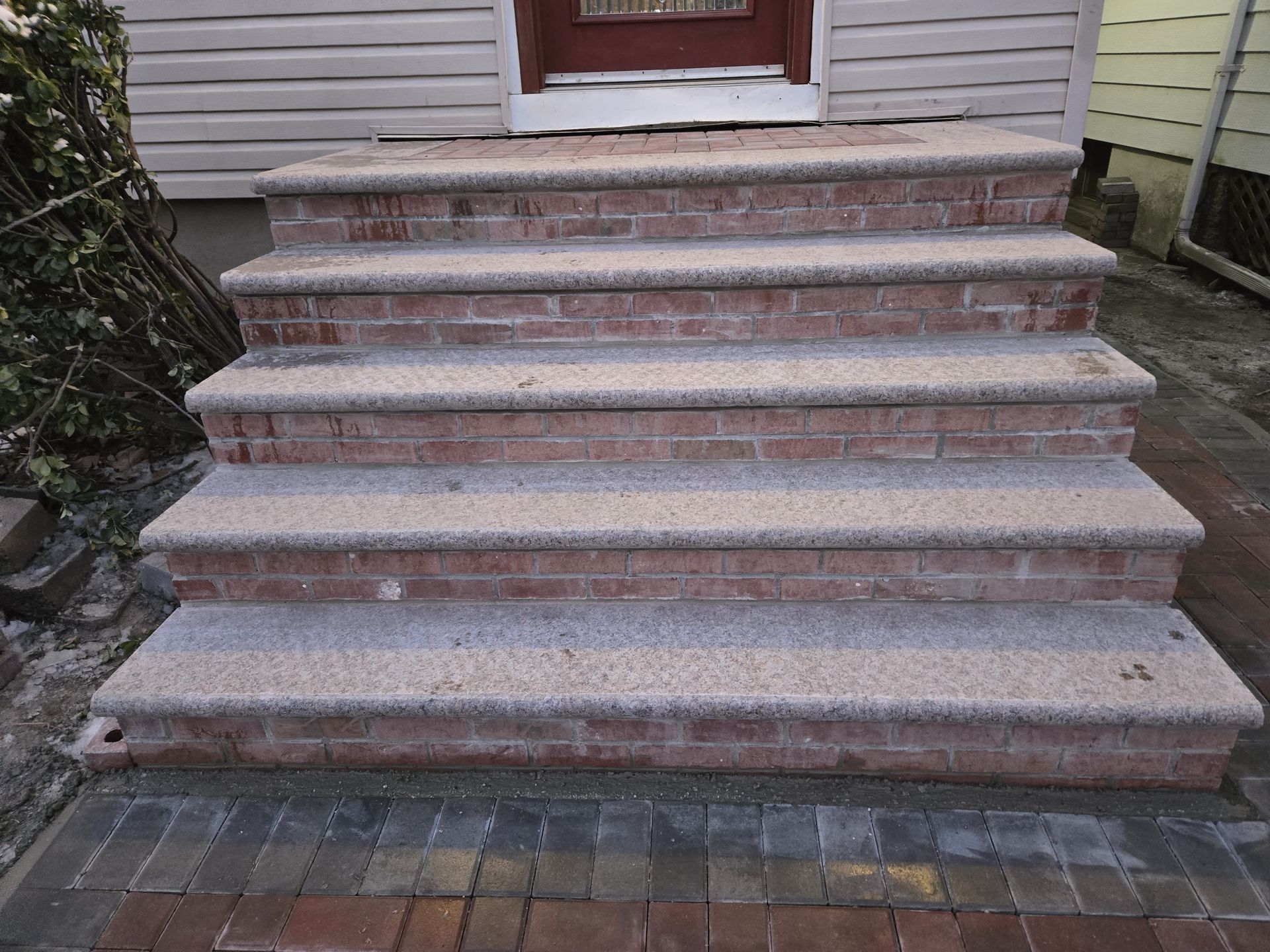 There are stairs leading up to the front of a house.