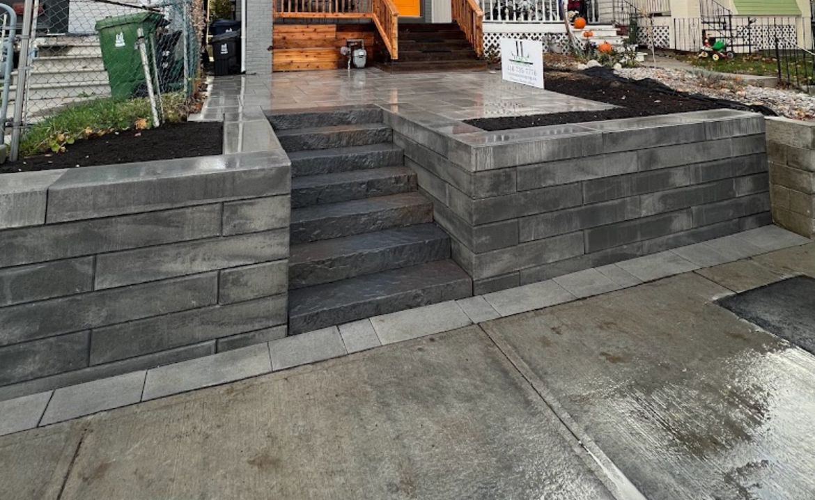 A brick wall with stairs leading up to a house.