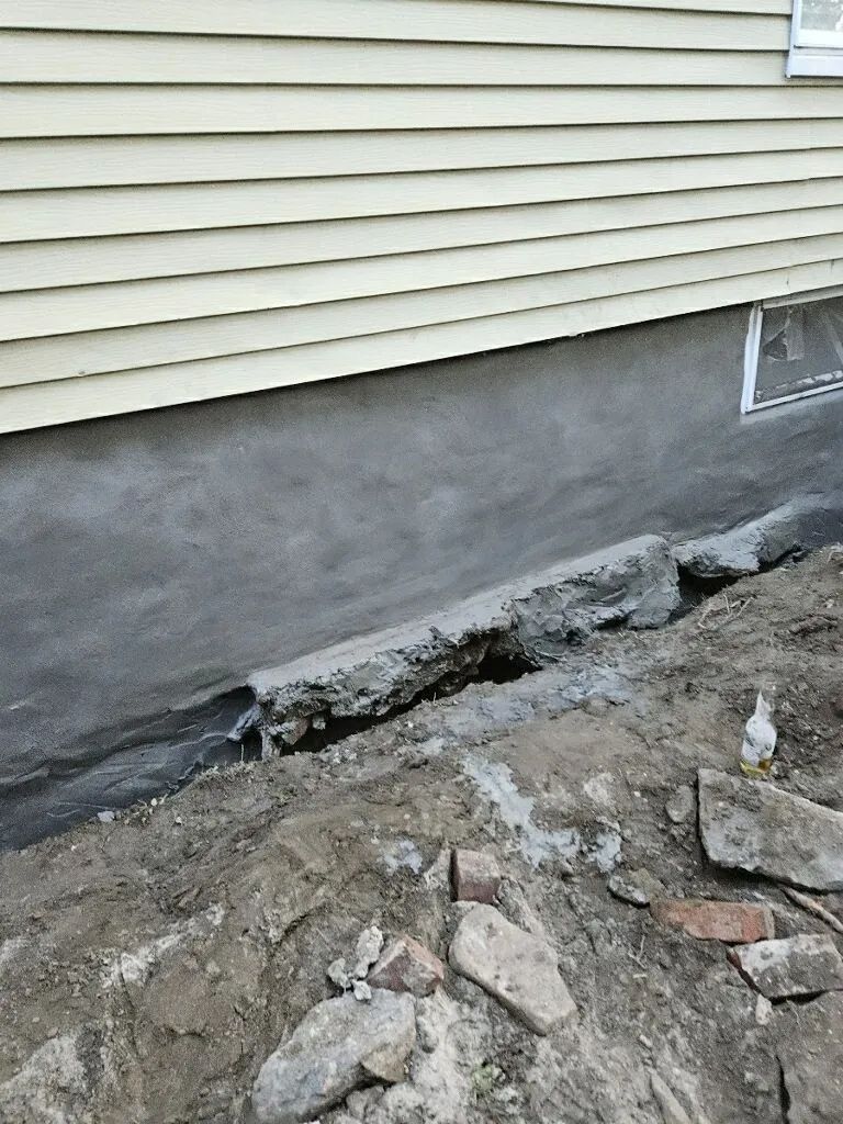 A house with a hole in the foundation is being remodeled.