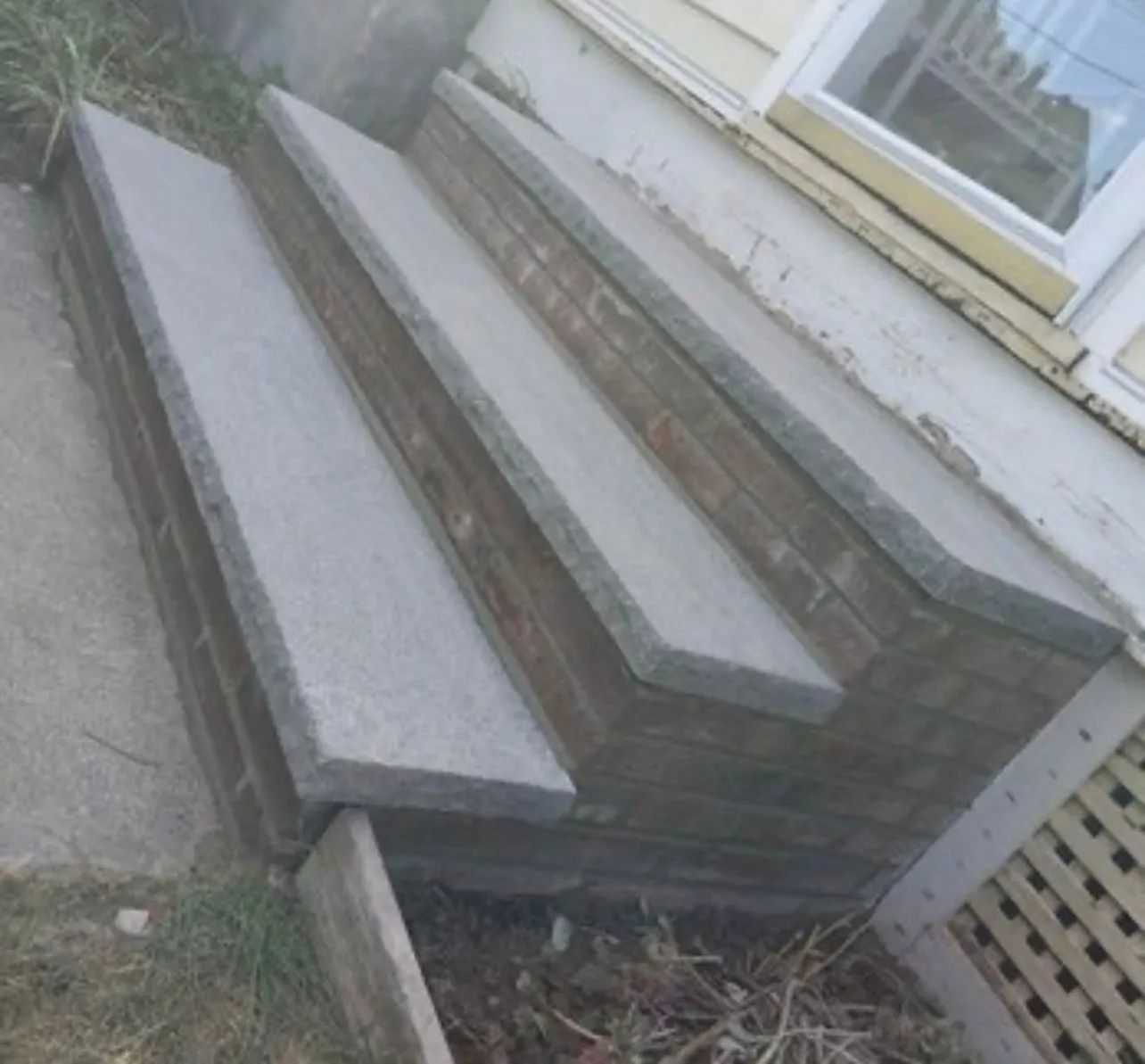 A set of concrete steps leading up to a house