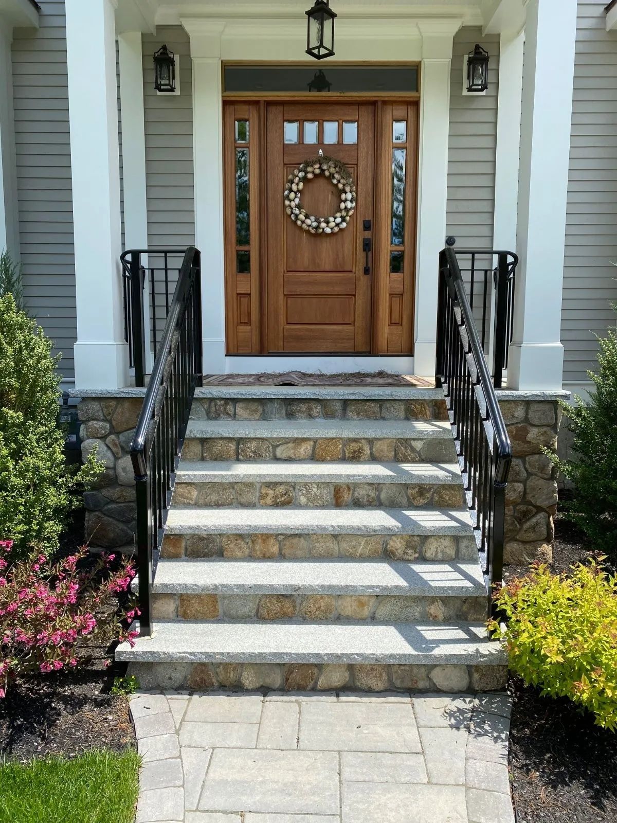 The front door of a house has a wreath on it