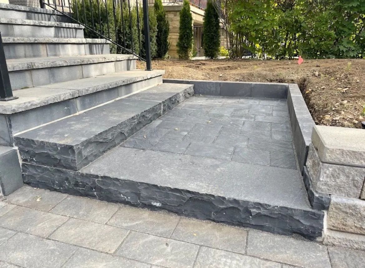 A set of stairs leading up to a stone walkway.