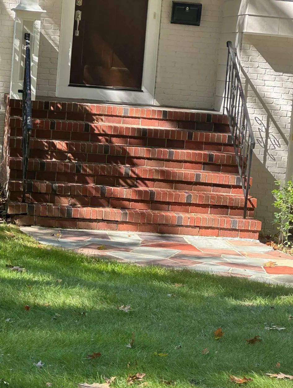 A house with brick steps leading up to the front door