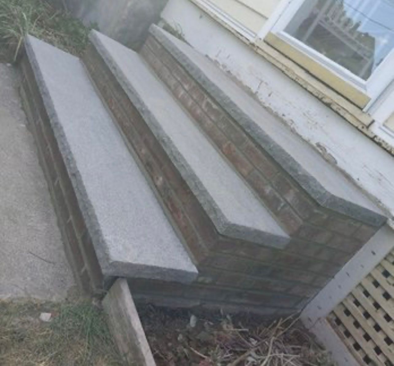 A set of concrete steps leading up to a house