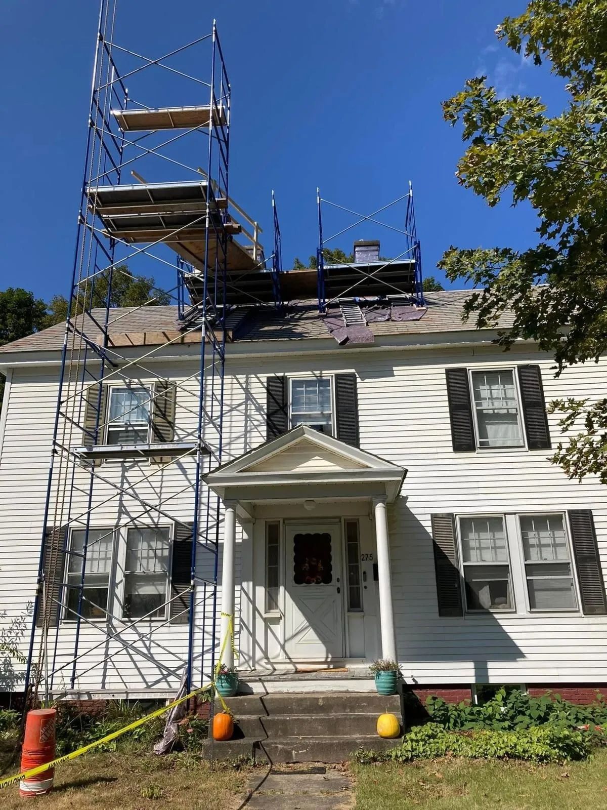 A white house with a scaffolding on top of it.