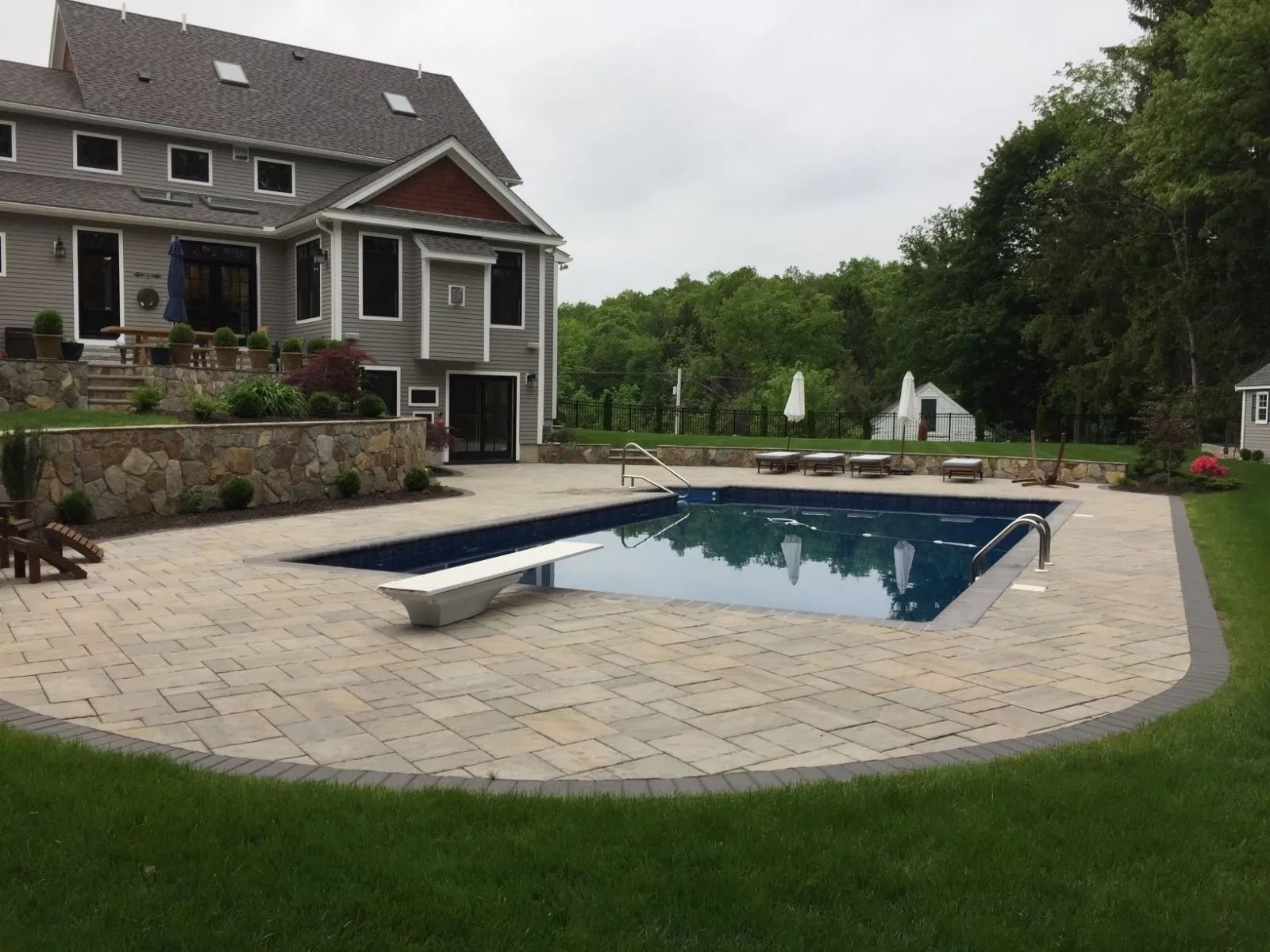 A large house with a large swimming pool in front of it