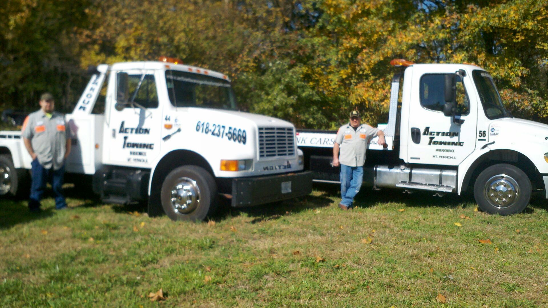 Man having a pose infront of two hauls