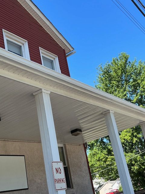 Red building with white trim, porch, and 