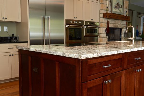 Modern kitchen with stainless steel appliances and a large granite island