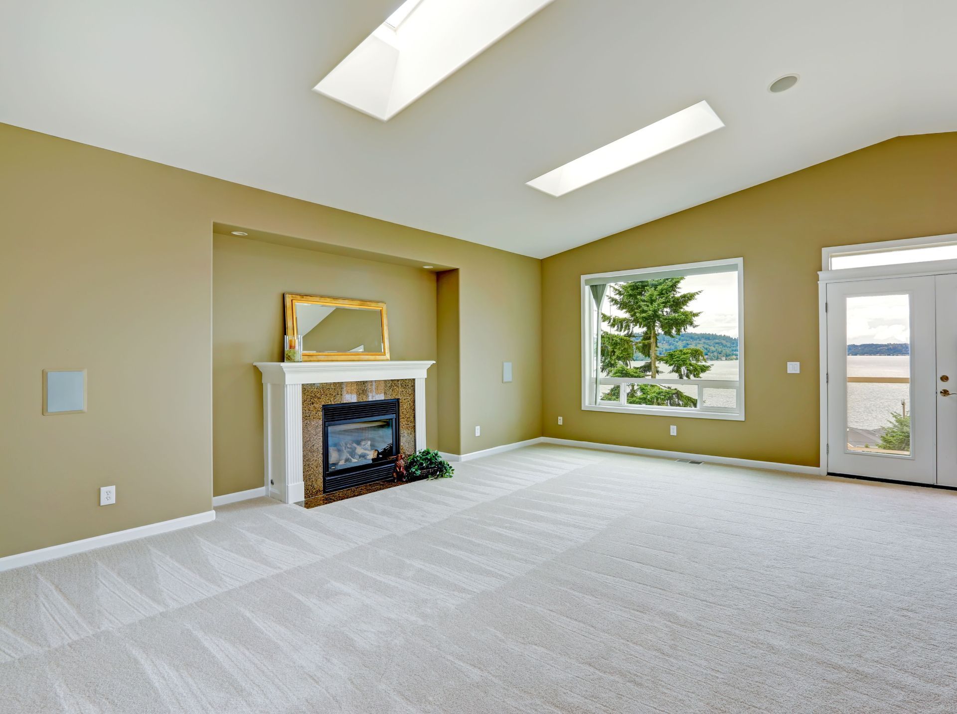 A living room with a large sectional couch and a rug.