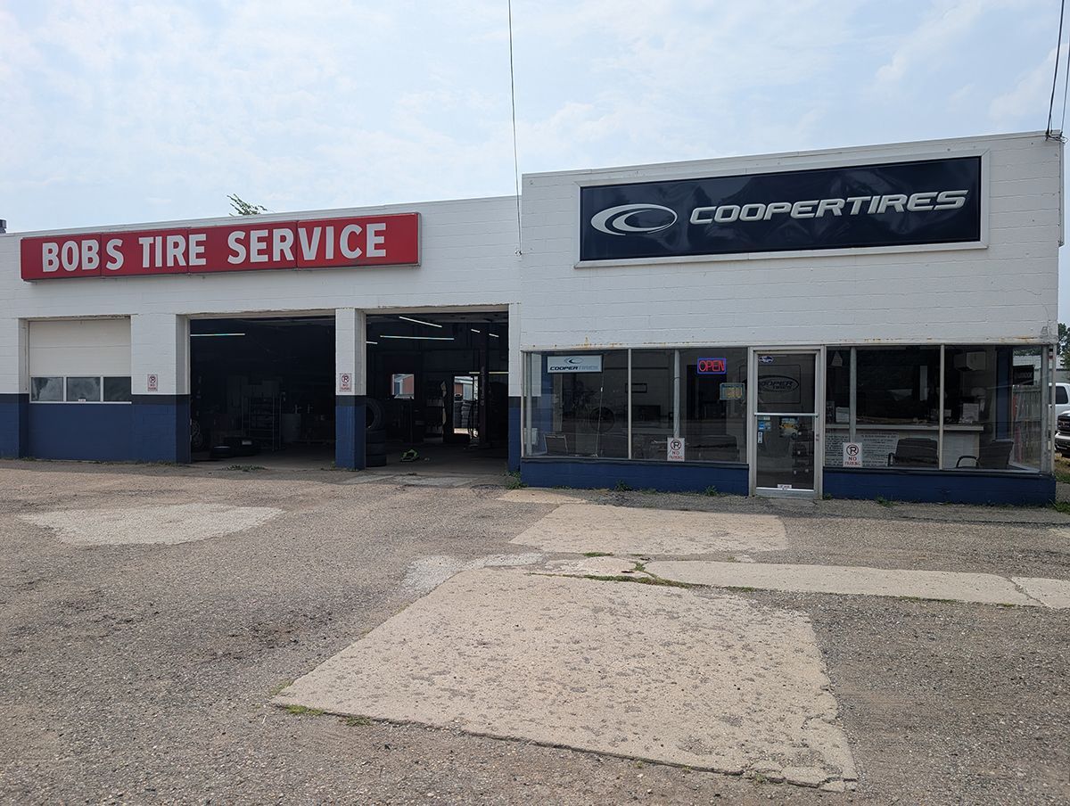 Bob's Tire Service storefront with Cooper Tires sign and open garage bays