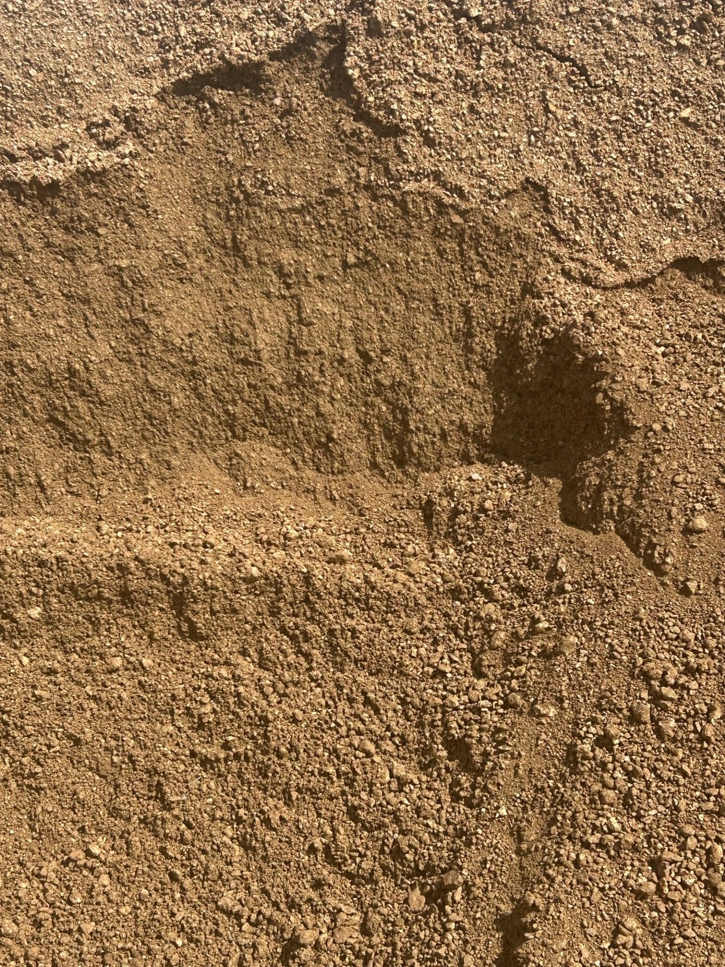A close up of a pile of dirt with a hole in it.