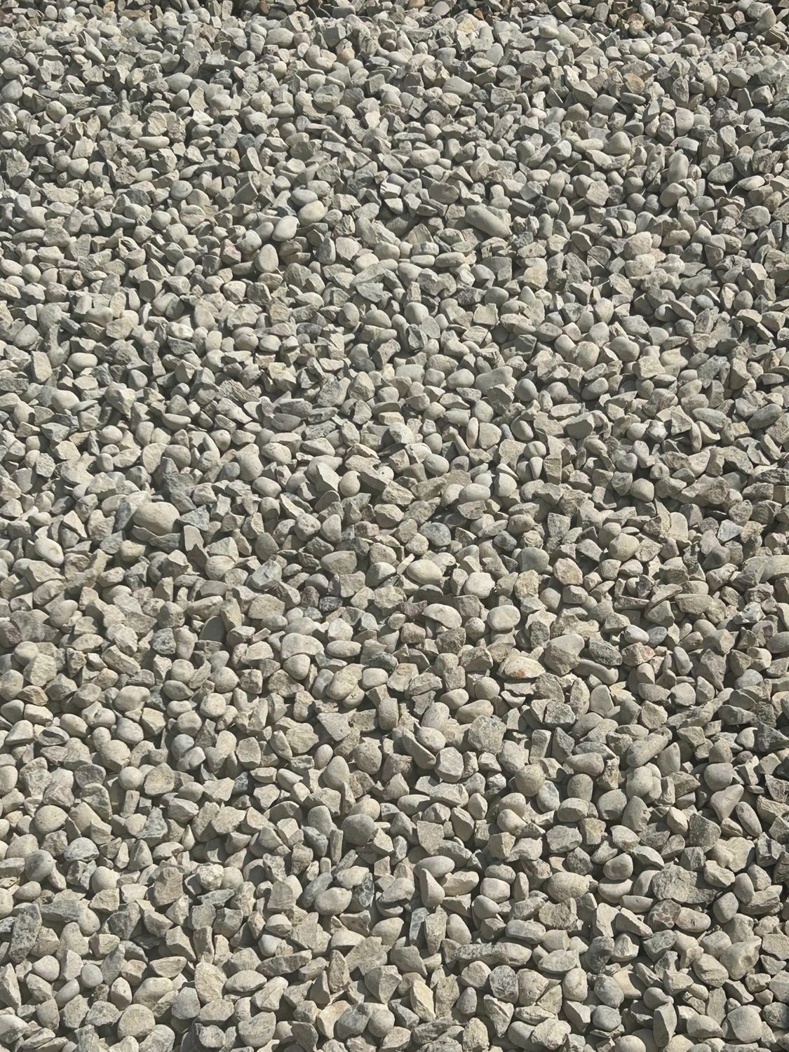 A pile of gravel is sitting on the ground.