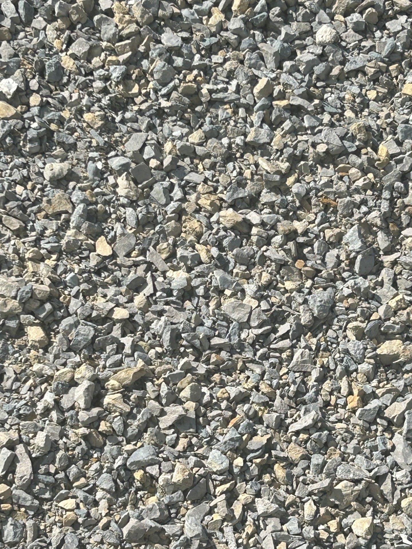 A pile of gravel is sitting on the ground.