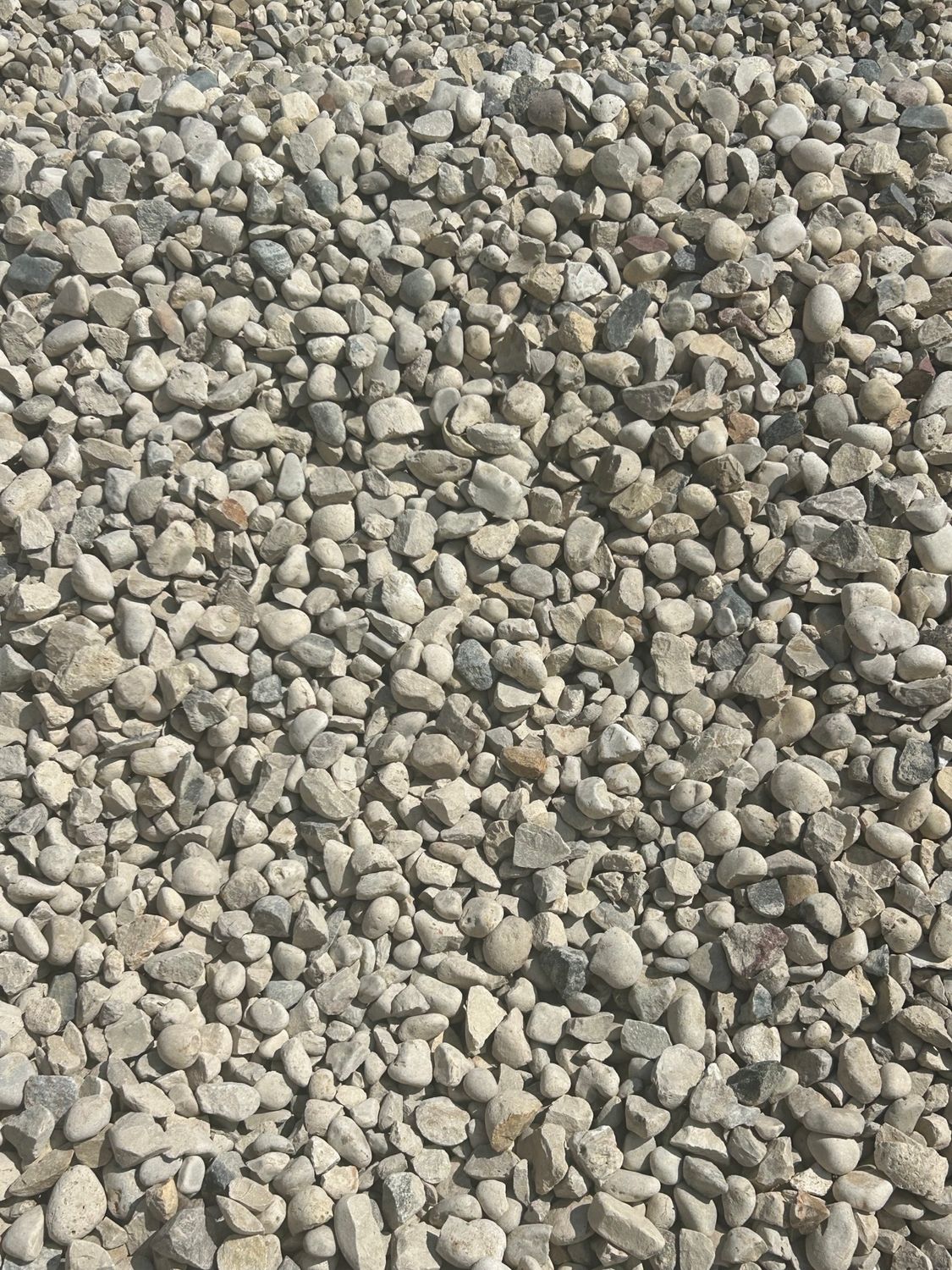 A pile of gravel is sitting on the ground.