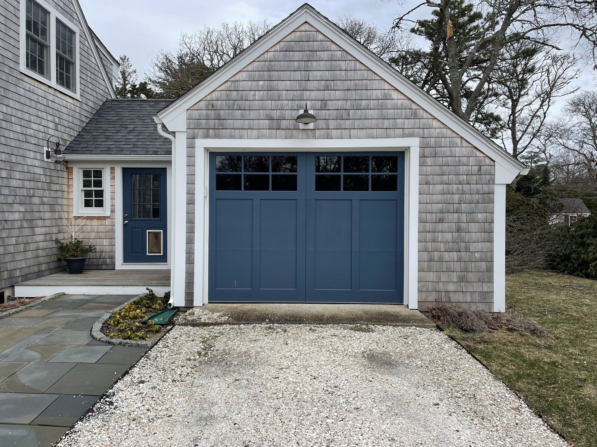 wood composite overlay blue door with driveway