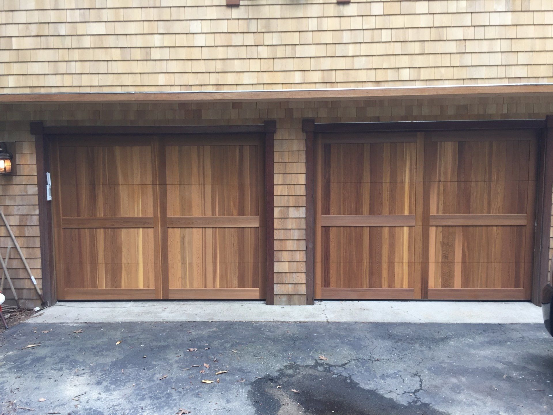 wood overlay garage door double with light bricks closer look
