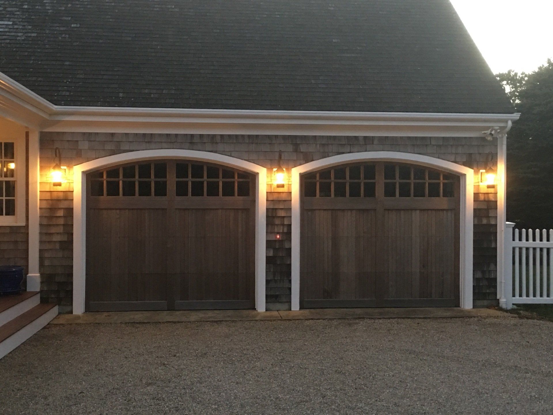 double garage door wood overlay with curved top and lights