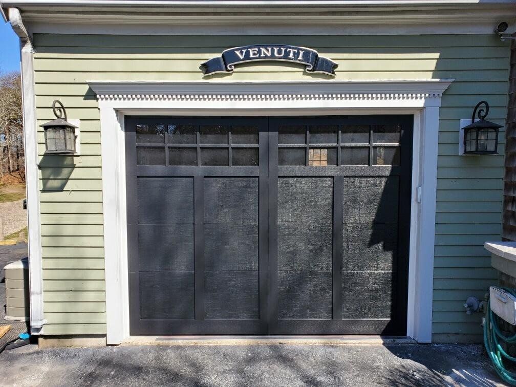 close up of black garage doors with beautiful white frame