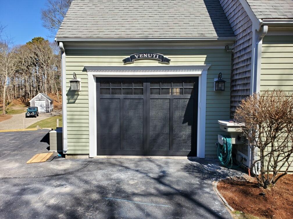 black garage doors with beautiful white frame