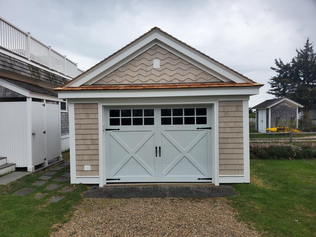 garage door with carriage-style design and black hardware