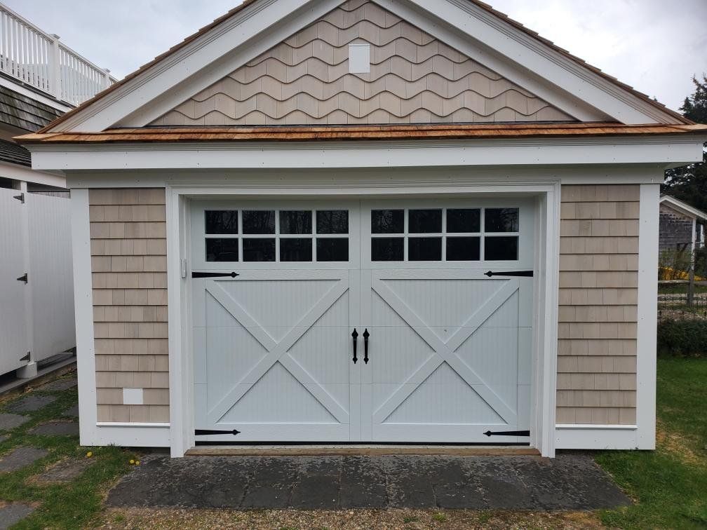 close up of garage door with carriage-style design and black hardware