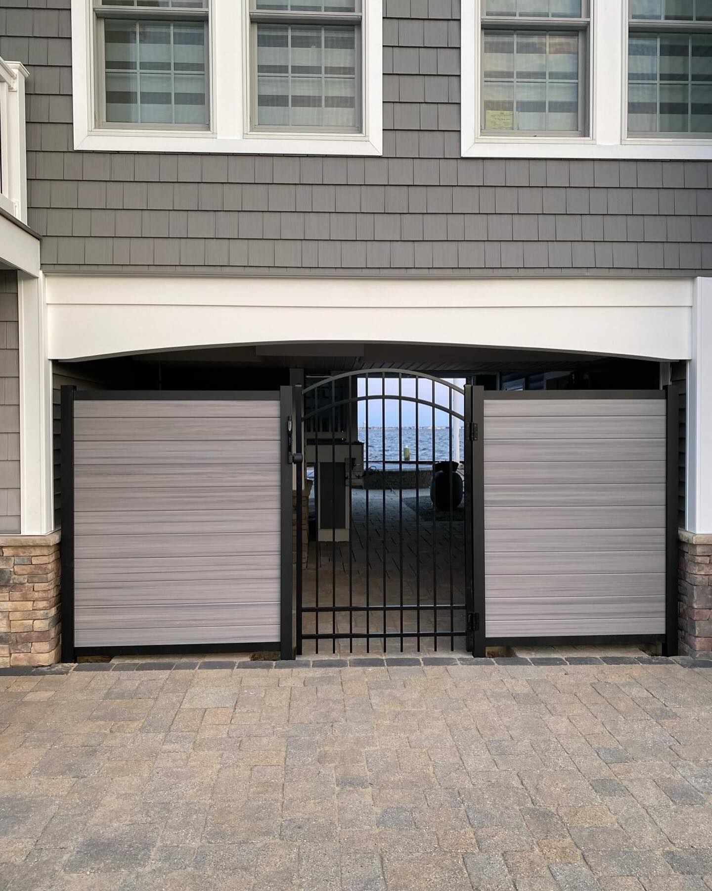 a garage with a gate and a view of the ocean .