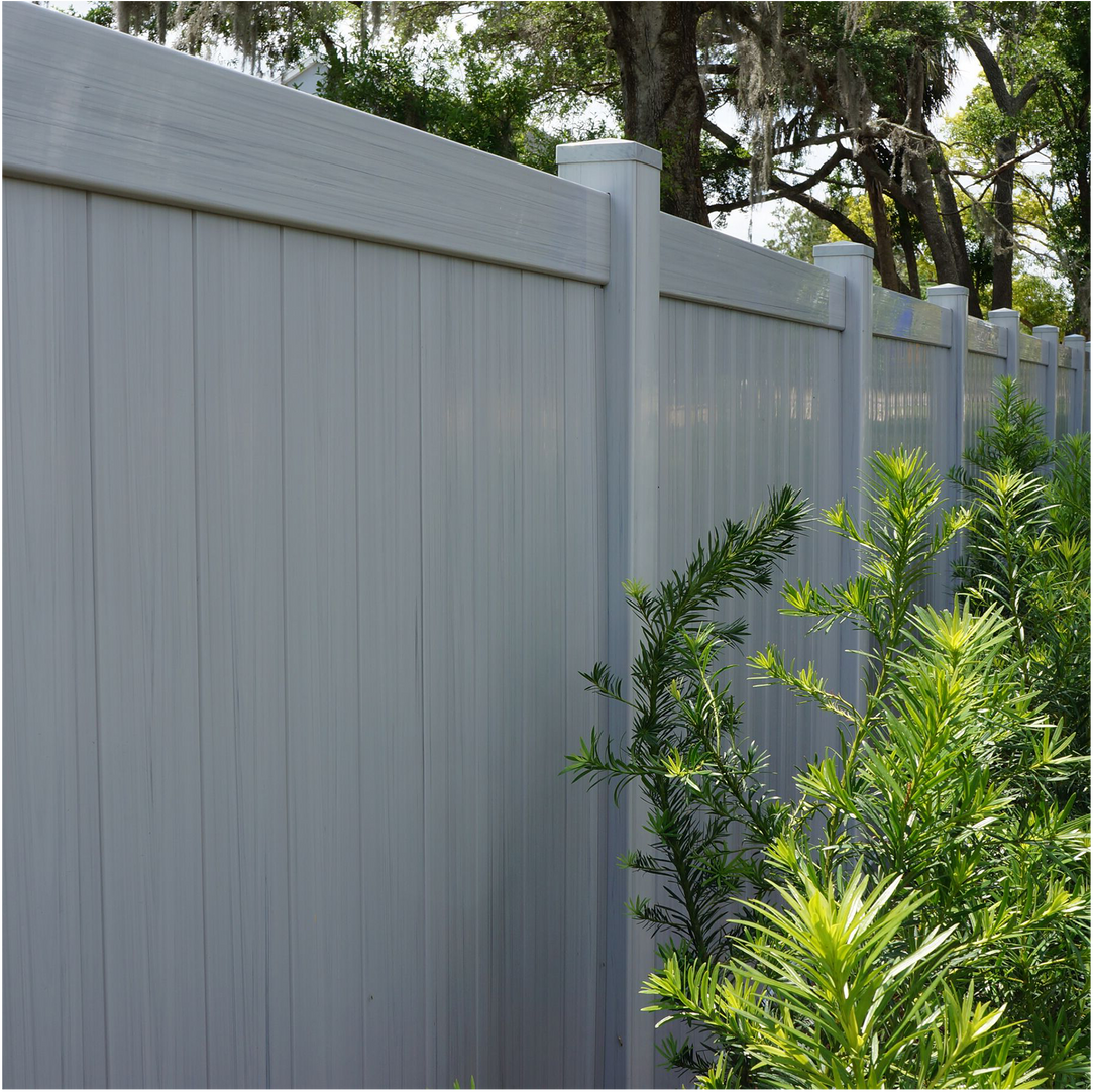 Light gray fence with plants