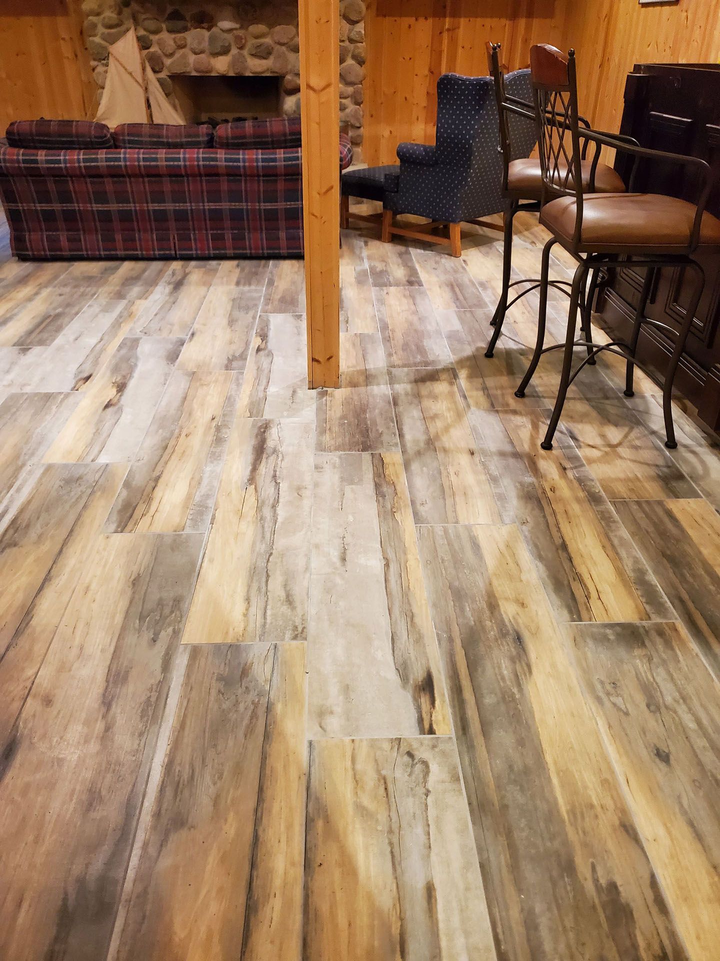 A living room with a wooden floor and a fireplace