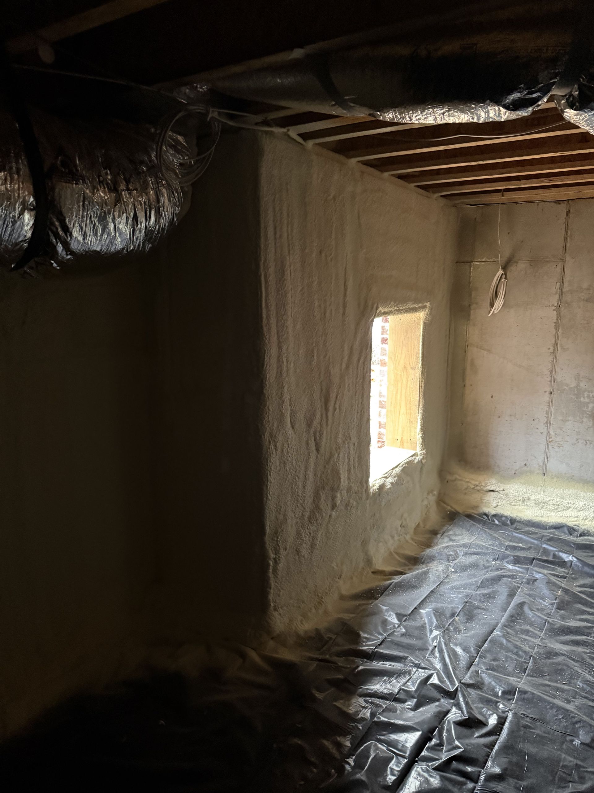 A room with a window and a lot of foam on the walls.