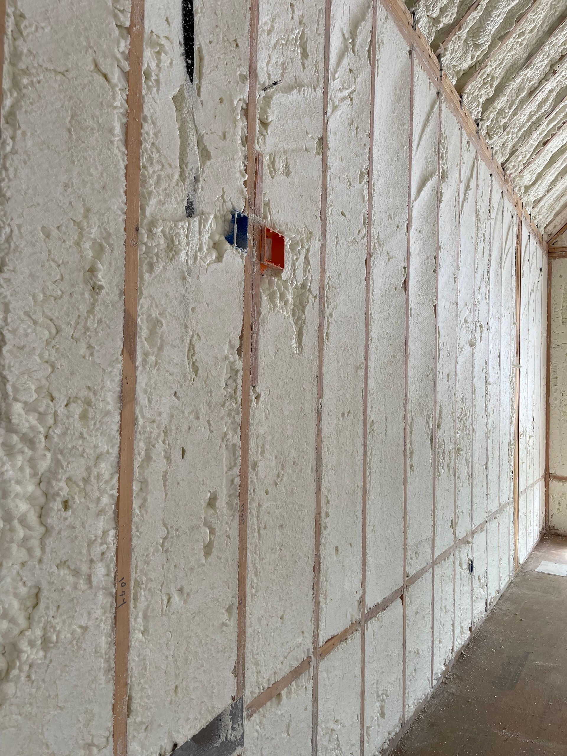 A long hallway with foam insulation on the walls.