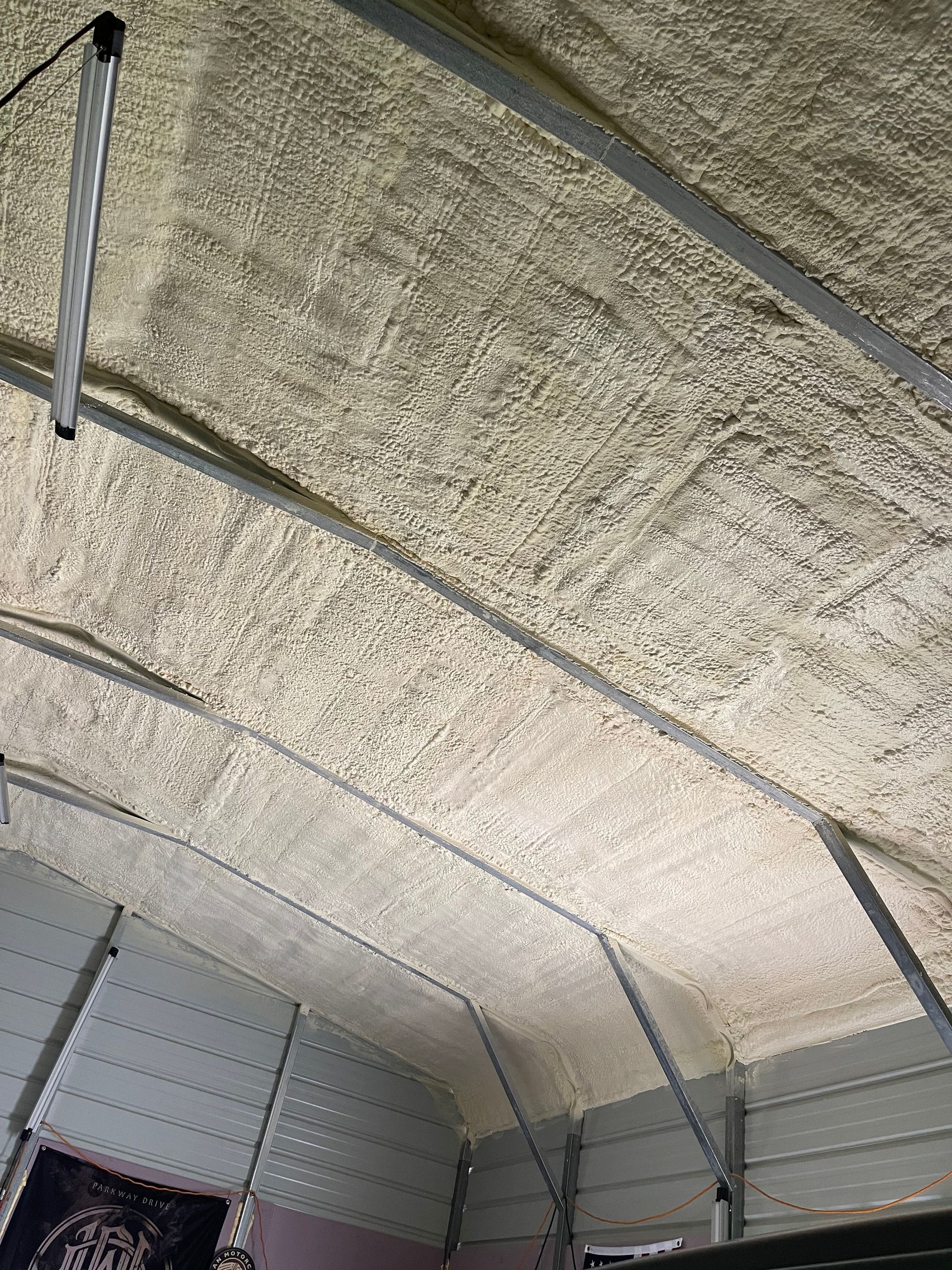 The ceiling of a garage with a lot of foam on it.