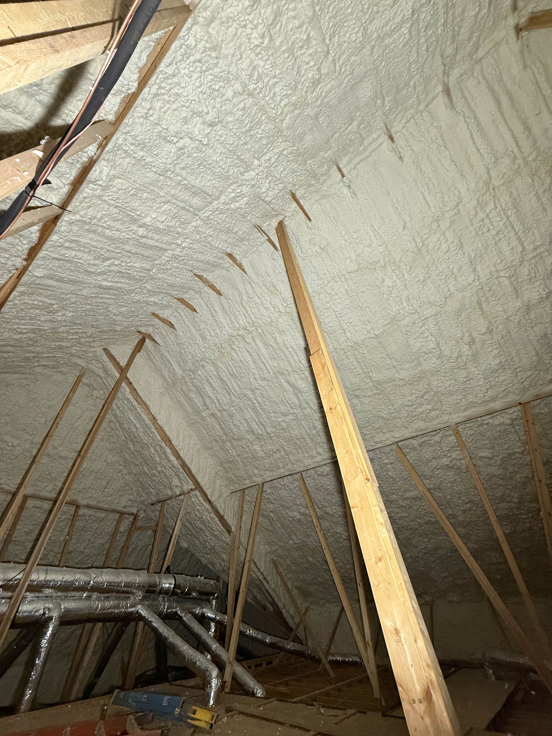 There is a lot of foam on the ceiling of the attic.
