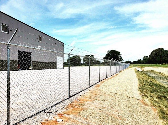 chain link fence with barbed wire at top