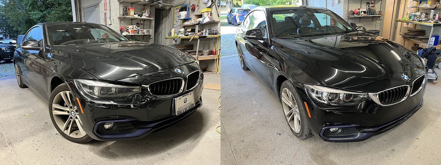 Two black BMW cars parked inside a garage.