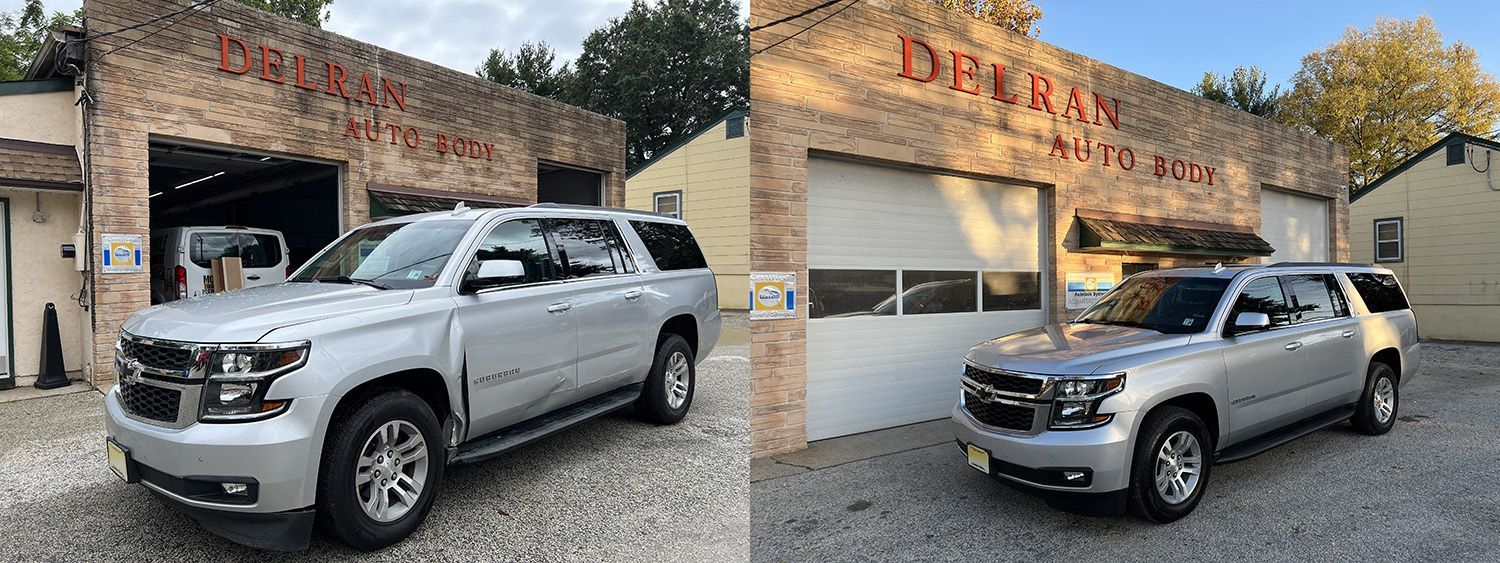 Two silver SUVs parked in front of a brick building with