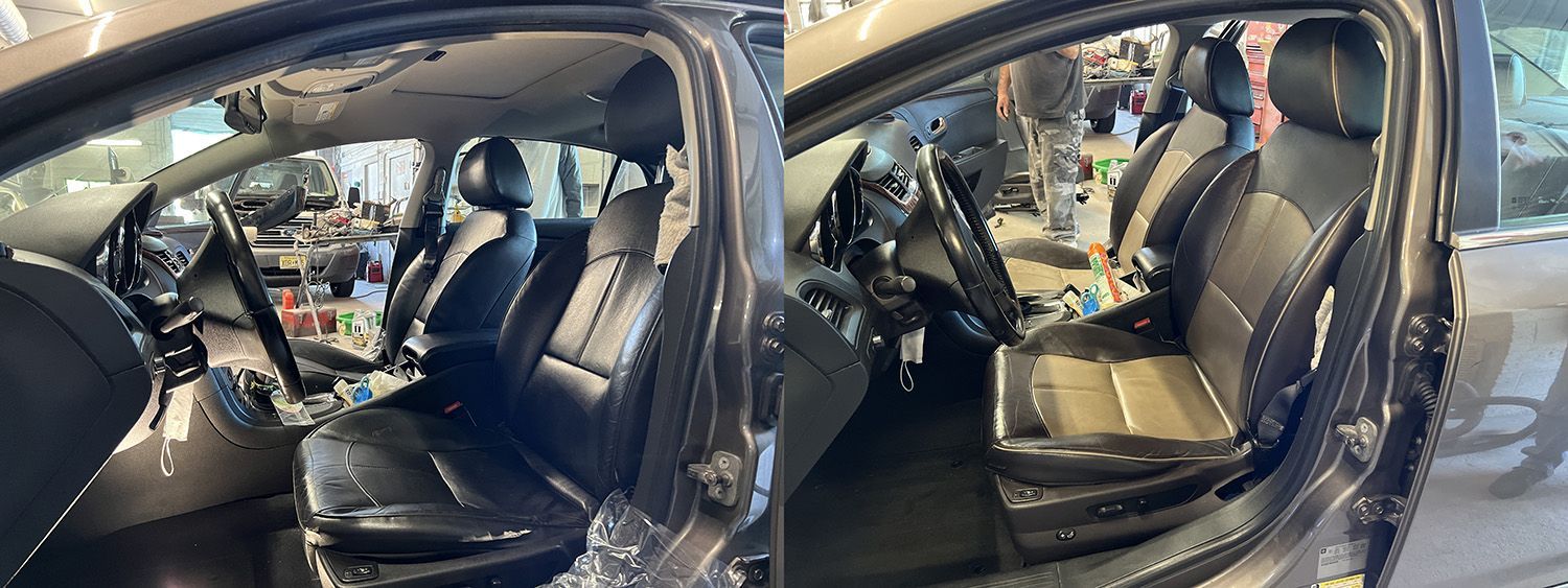 Interior view of a black car with leather seats.