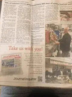 A newspaper is open to a page that says take us with youl.